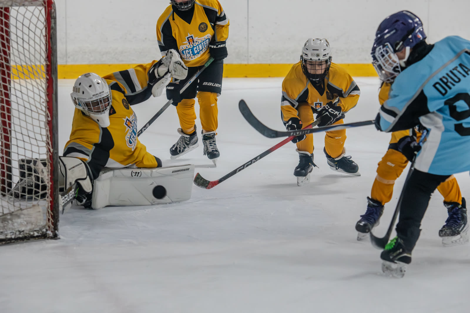Youth hockey game in progress on the ice at Las Vegas Ice Center